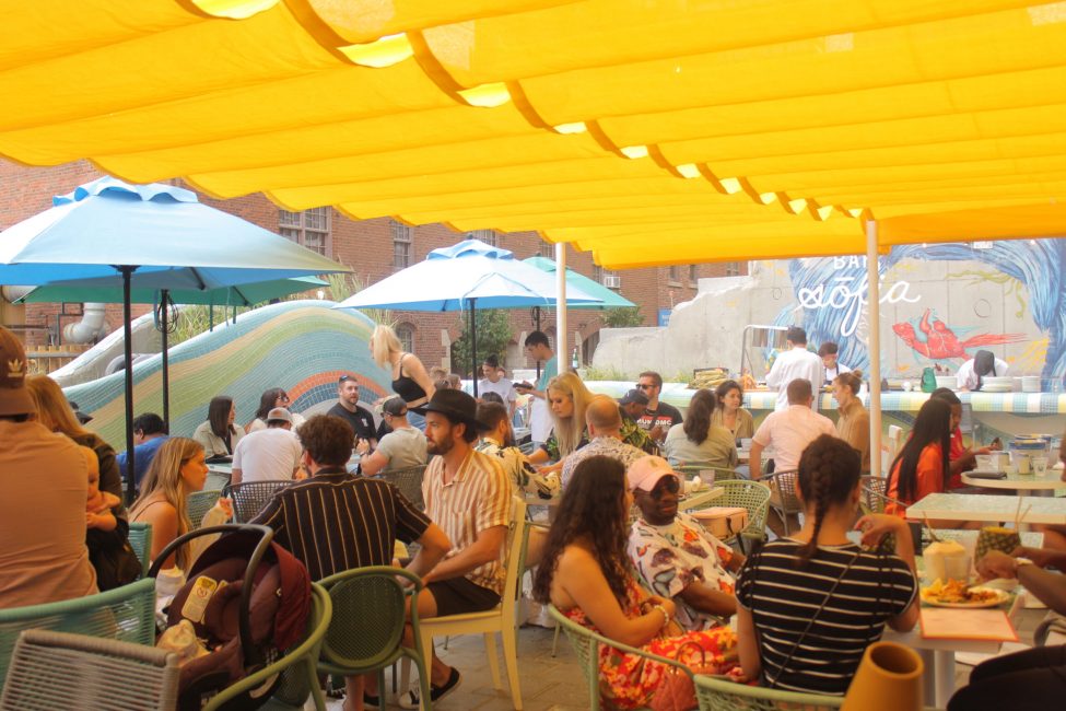 outdoor patio filled with people enjoying the sun